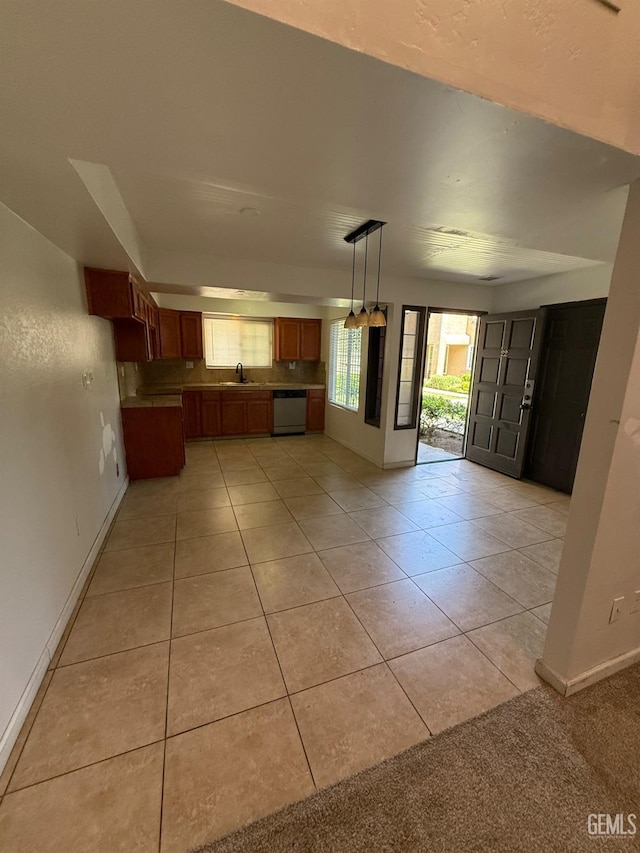 3600 O St Unit 22, Bakersfield, CA 93301 - kitchen featuring stainless steel dishwasher, brown cabinets, a sink, and light tile patterned floors