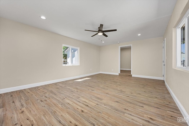 empty room with a ceiling fan, light wood finished floors, recessed lighting, and baseboards