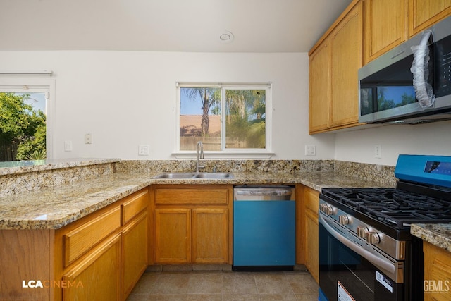 6905 Gwenivere Ct, Bakersfield, CA 93313 - kitchen with appliances with stainless steel finishes, a peninsula, light stone countertops, and brown cabinets