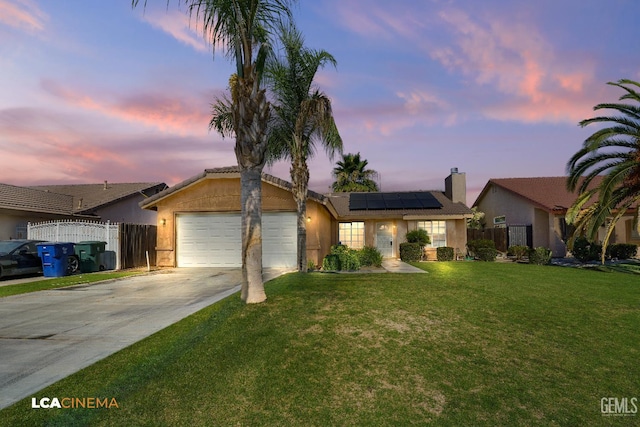 6905 Gwenivere Ct, Bakersfield, CA 93313 - ranch-style home featuring solar panels, concrete driveway, a garage, stucco siding, and a chimney