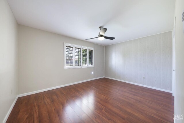 408 Pebble Beach Dr, Bakersfield, CA 93309 - spare room featuring baseboards, a ceiling fan, and dark wood-style floors