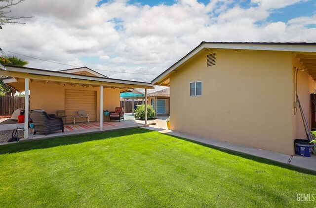 408 Pebble Beach Dr, Bakersfield, CA 93309 - back of house with a yard, stucco siding, and fence