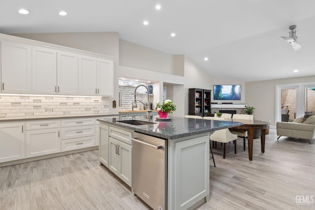 8220 Birmingham St, Bakersfield, CA 93311 - kitchen with a sink, stainless steel dishwasher, open floor plan, tasteful backsplash, and white cabinetry