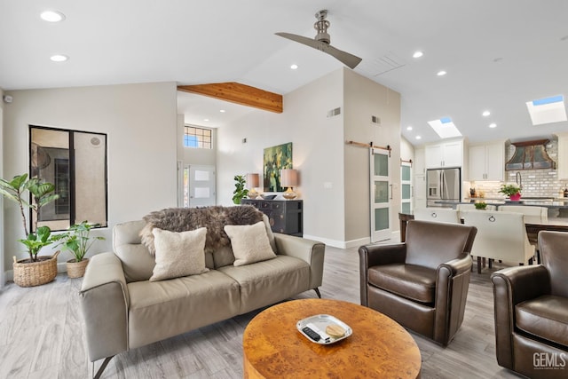 8220 Birmingham St, Bakersfield, CA 93311 - living area featuring a barn door, high vaulted ceiling, recessed lighting, a ceiling fan, and light wood-type flooring