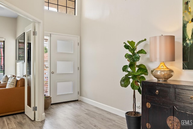 8220 Birmingham St, Bakersfield, CA 93311 - entrance foyer with baseboards, light wood-style flooring, and a towering ceiling
