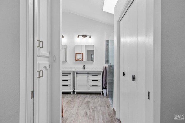 8220 Birmingham St, Bakersfield, CA 93311 - bathroom with lofted ceiling, vanity, a shower with door, and wood finished floors