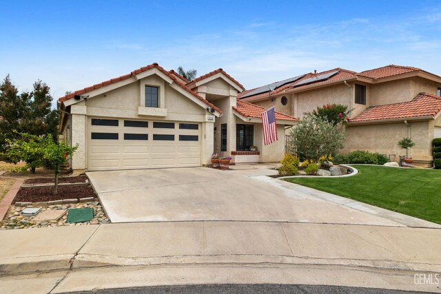 8220 Birmingham St, Bakersfield, CA 93311 - view of front of home with stucco siding, driveway, an attached garage, a front yard, and a tiled roof