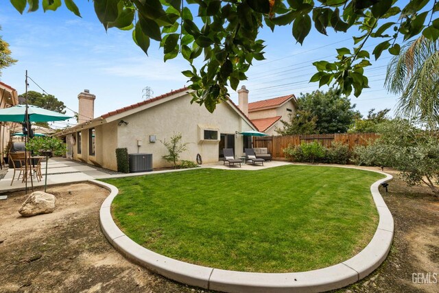 8220 Birmingham St, Bakersfield, CA 93311 - rear view of property with a patio area, stucco siding, a chimney, and central air condition unit