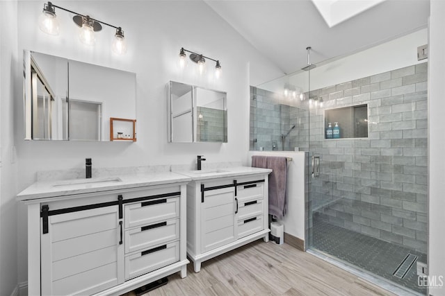 8220 Birmingham St, Bakersfield, CA 93311 - full bath featuring double vanity, wood finished floors, a shower stall, and lofted ceiling