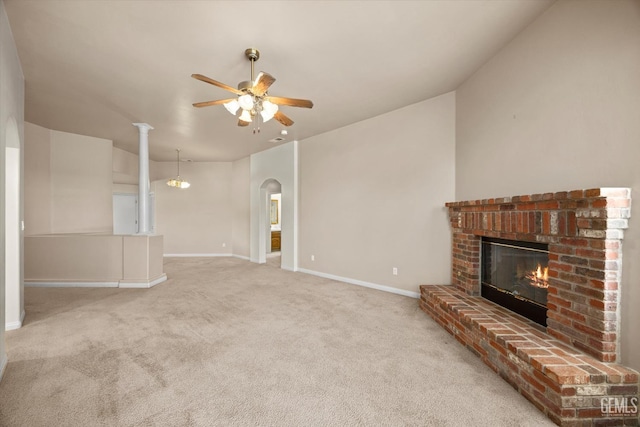 10200 Cheyenne Dr, Bakersfield, CA 93312 - unfurnished living room featuring a ceiling fan, a fireplace, carpet floors, and arched walkways