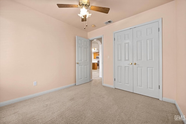 10200 Cheyenne Dr, Bakersfield, CA 93312 - unfurnished bedroom featuring light colored carpet, ceiling fan, a closet, and arched walkways