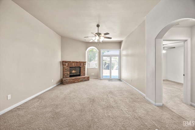 10200 Cheyenne Dr, Bakersfield, CA 93312 - unfurnished living room featuring ceiling fan, carpet floors, arched walkways, and a brick fireplace