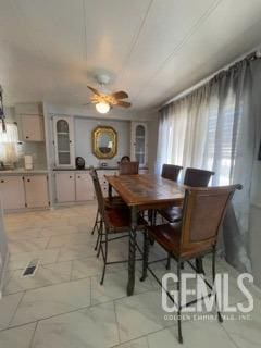 dining space featuring ceiling fan