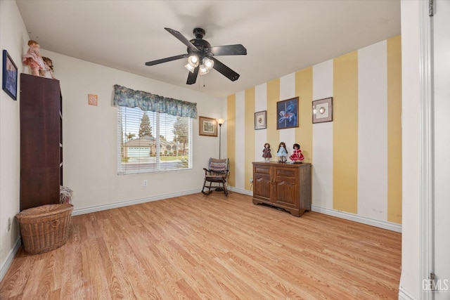 living room with light hardwood / wood-style floors and ceiling fan