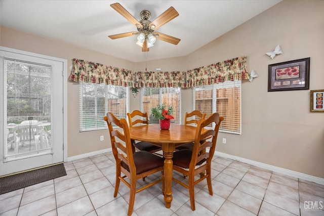 tiled dining space featuring ceiling fan