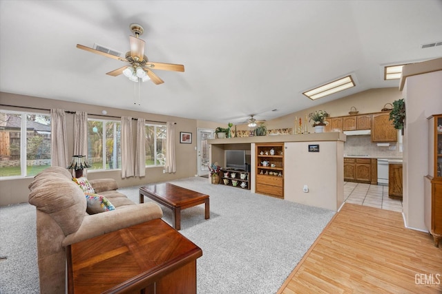 living room with lofted ceiling, light hardwood / wood-style floors, and ceiling fan