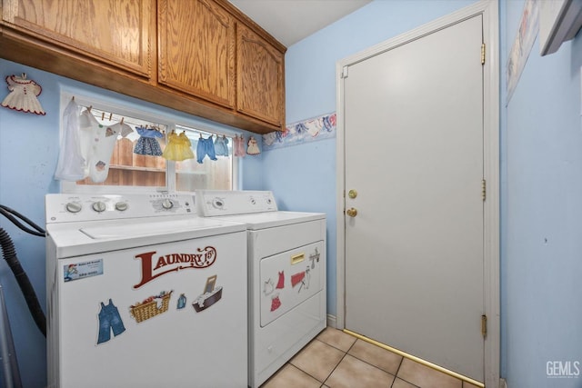 laundry area with cabinets, separate washer and dryer, and light tile patterned floors