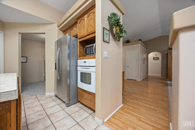 kitchen with stainless steel appliances and light hardwood / wood-style floors