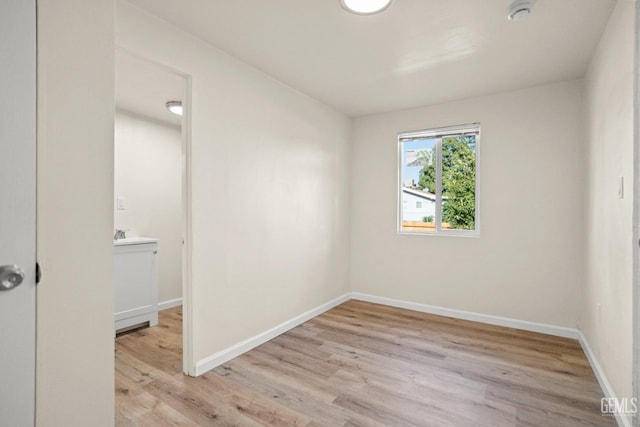 empty room with light hardwood / wood-style flooring