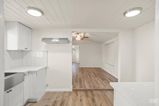 kitchen with white cabinetry, light hardwood / wood-style flooring, ceiling fan, and range hood