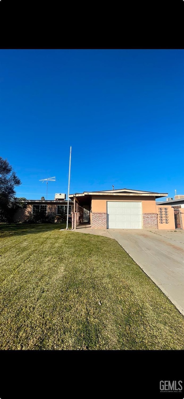 view of front of property with a front yard and a garage