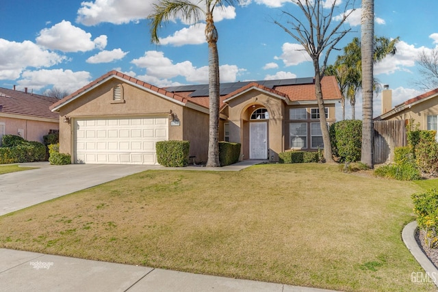 view of front of house featuring an attached garage, driveway, roof mounted solar panels, stucco siding, and a front yard