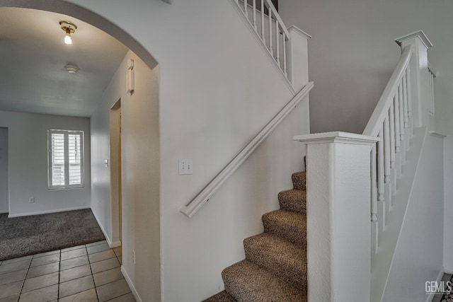 stairway featuring tile patterned floors