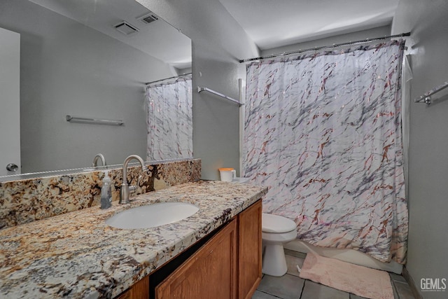 bathroom featuring tile patterned floors, walk in shower, vanity, and toilet