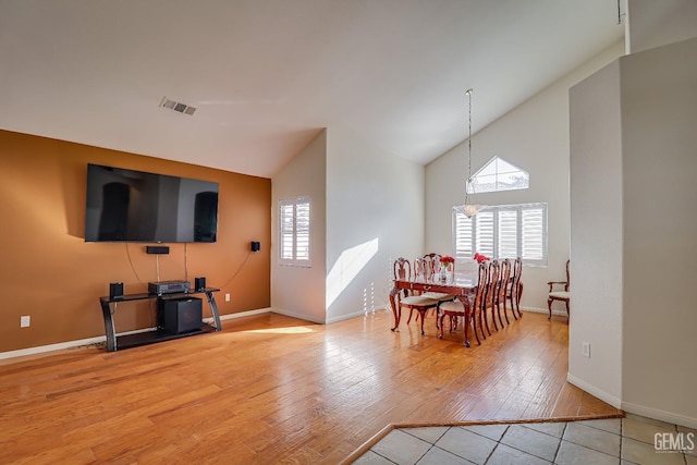 dining space with hardwood / wood-style floors and lofted ceiling