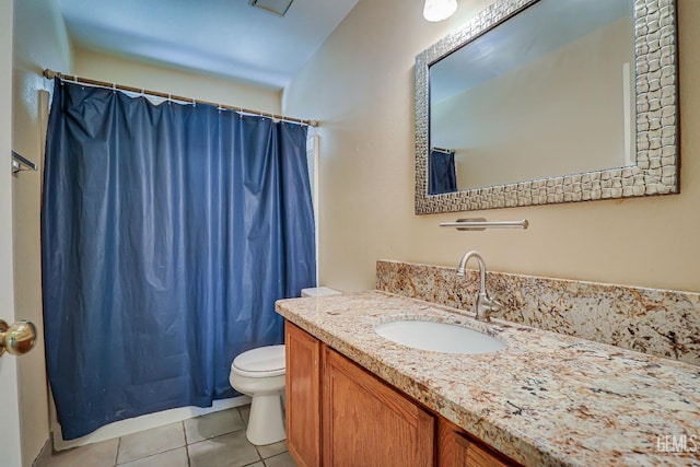 bathroom featuring toilet, vanity, tile patterned floors, and walk in shower