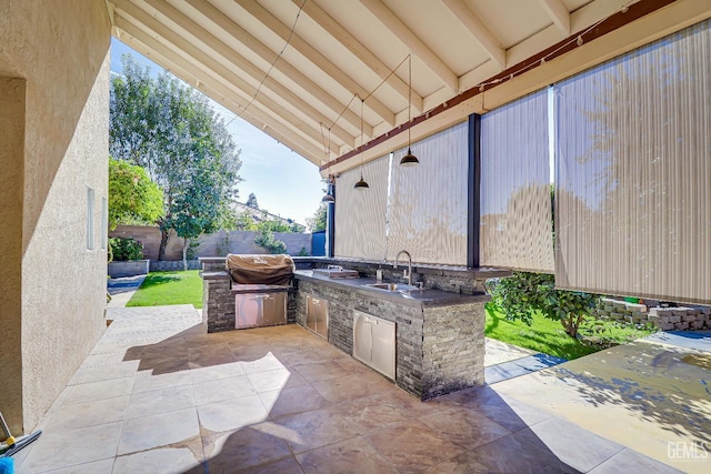 view of patio featuring area for grilling and sink