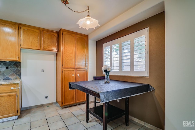 kitchen featuring light tile patterned floors and backsplash