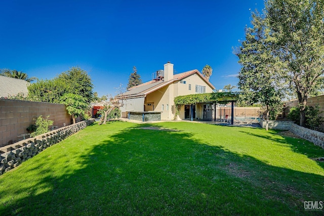 rear view of house with a yard