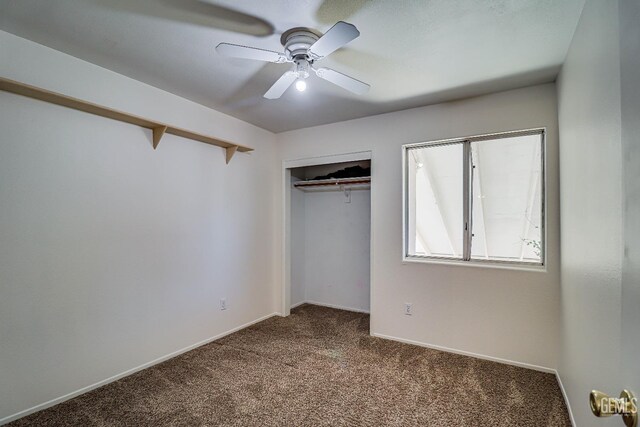 unfurnished bedroom with ceiling fan, carpet floors, and a closet