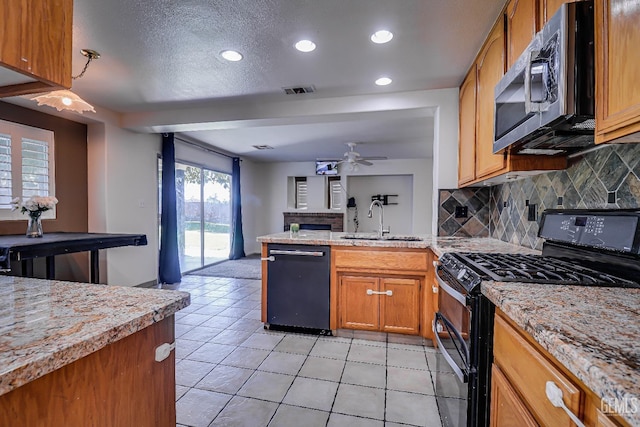 kitchen featuring tasteful backsplash, ceiling fan, sink, black appliances, and light tile patterned flooring