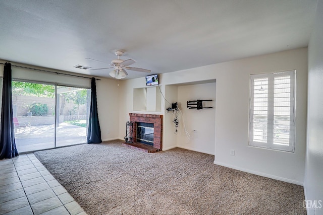 unfurnished living room featuring tile patterned flooring, ceiling fan, and a fireplace