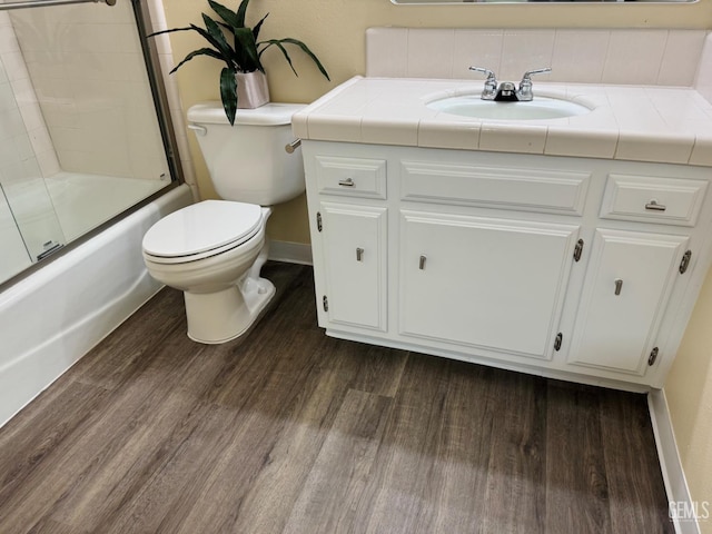 4208 Tierra Verde St Unit 2, Bakersfield, CA 93301 - full bathroom with vanity, shower / bath combination with glass door, wood finished floors, and tasteful backsplash