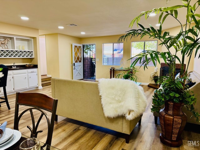 4208 Tierra Verde St Unit 2, Bakersfield, CA 93301 - living room with bar area, light wood-style floors, and recessed lighting