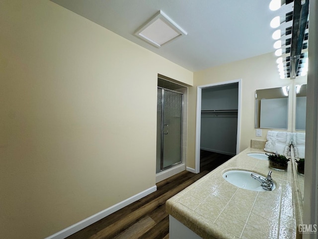 4208 Tierra Verde St Unit 2, Bakersfield, CA 93301 - full bathroom featuring a shower stall, double vanity, a spacious closet, and wood finished floors