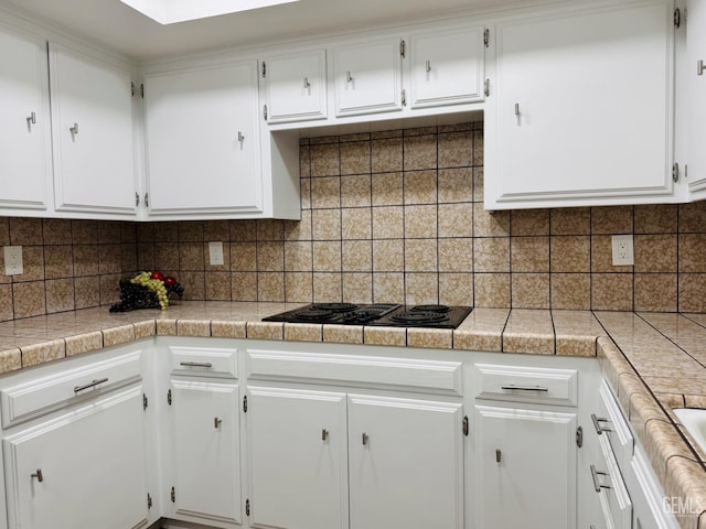4208 Tierra Verde St Unit 2, Bakersfield, CA 93301 - kitchen featuring white cabinets, tasteful backsplash, tile counters, and black electric stovetop