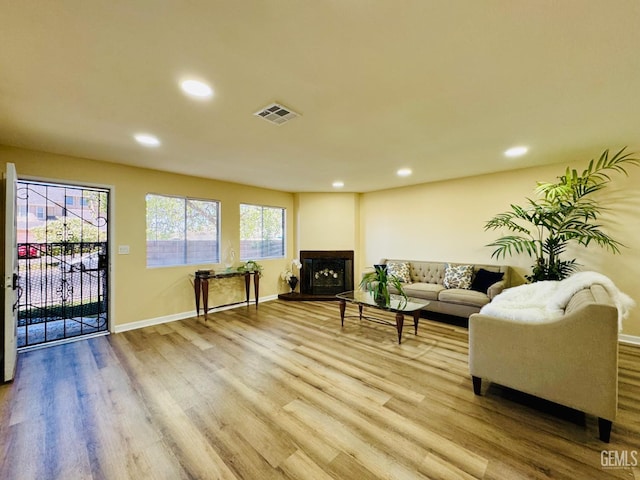 4208 Tierra Verde St Unit 2, Bakersfield, CA 93301 - living room with wood finished floors, recessed lighting, and a fireplace with raised hearth