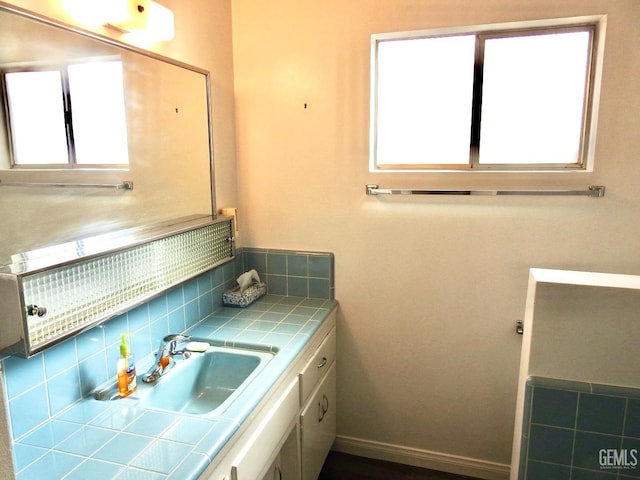 bathroom featuring tasteful backsplash and vanity