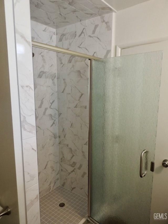 bathroom with a shower with shower door