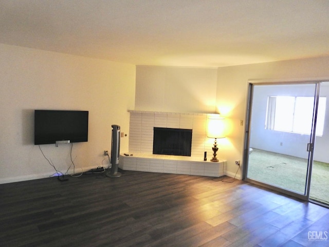 unfurnished living room with a fireplace and wood-type flooring