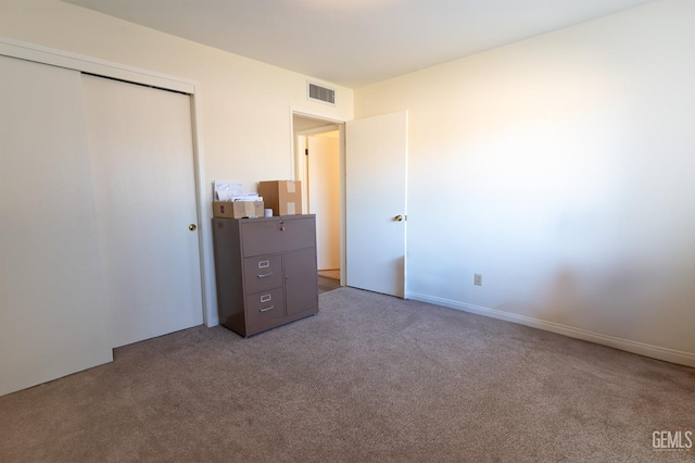 unfurnished bedroom with carpet and a closet