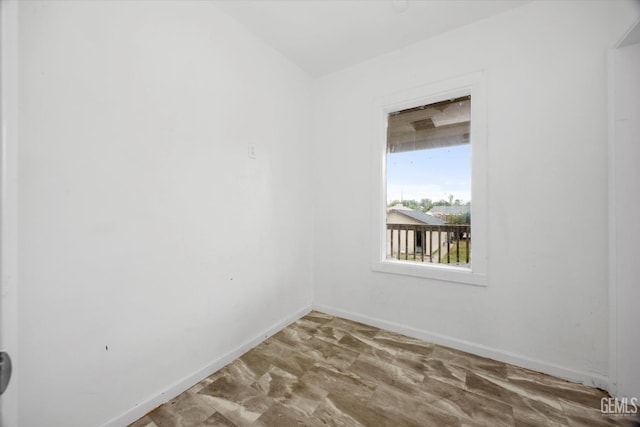 spare room featuring baseboards