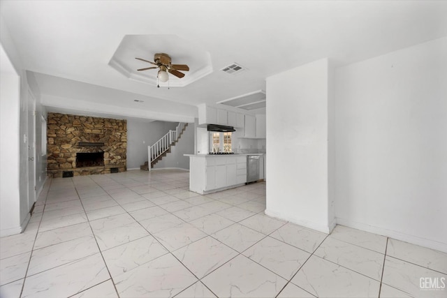 unfurnished living room with baseboards, a stone fireplace, marble finish floor, visible vents, and ceiling fan