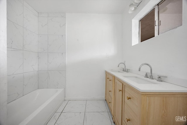 full bath featuring a sink, double vanity, and marble finish floor