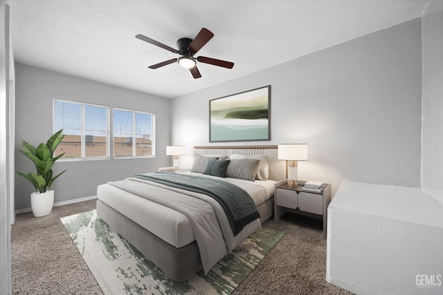 bedroom with ceiling fan, carpet floors, and baseboards