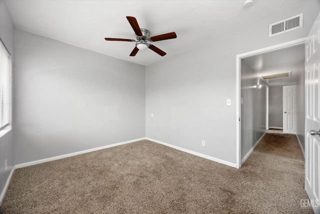 carpeted empty room featuring a ceiling fan, baseboards, and visible vents